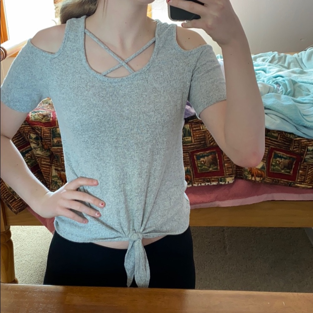 Shoulder cut out, crosses in front, ties at bottom